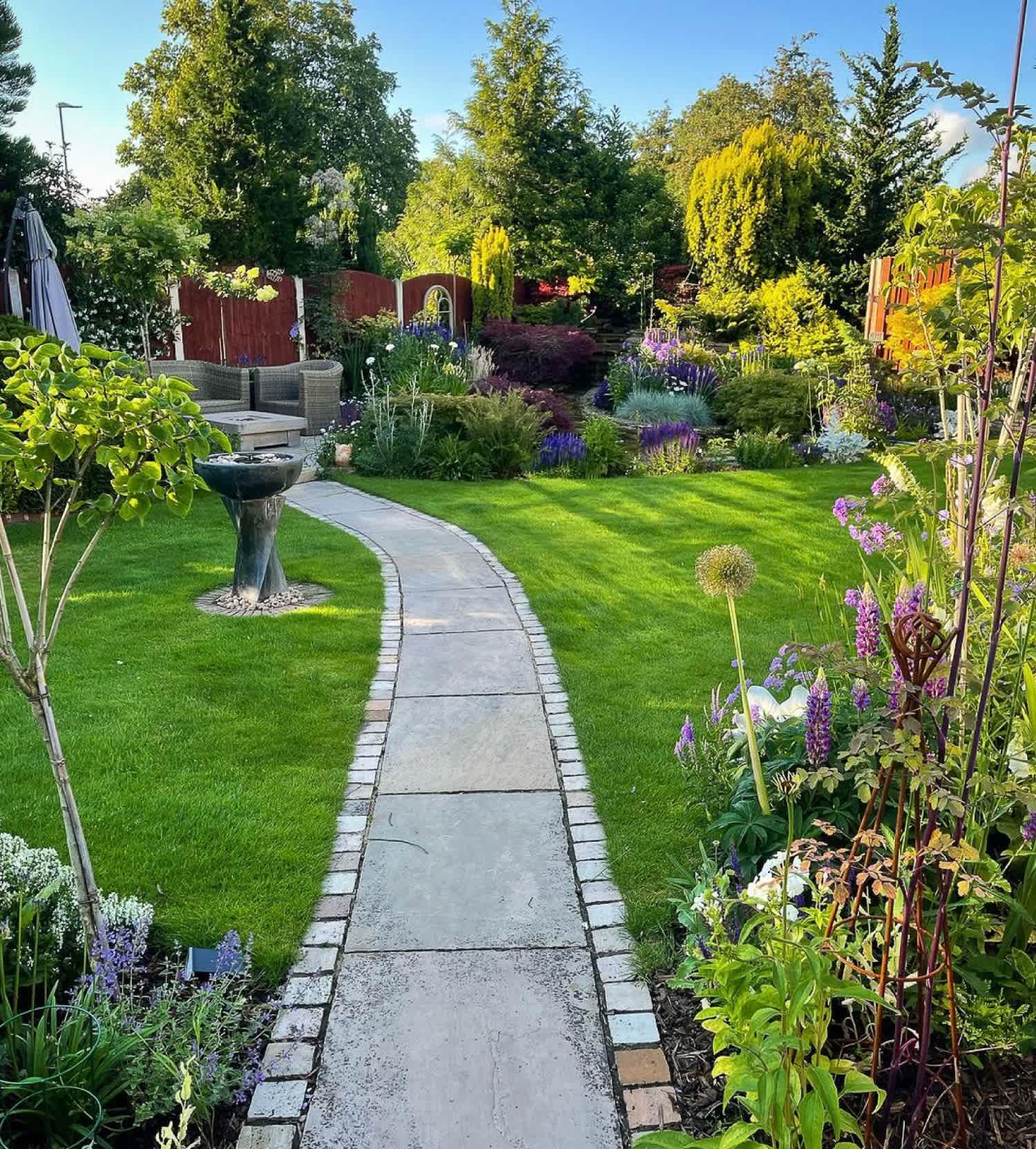 A curved pathway with brick edging