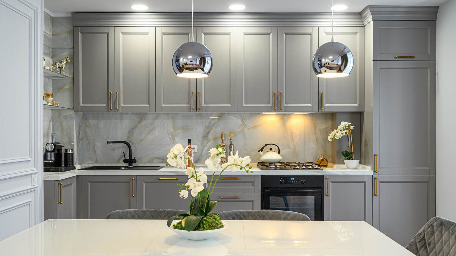 A kitchen with gray cabinets