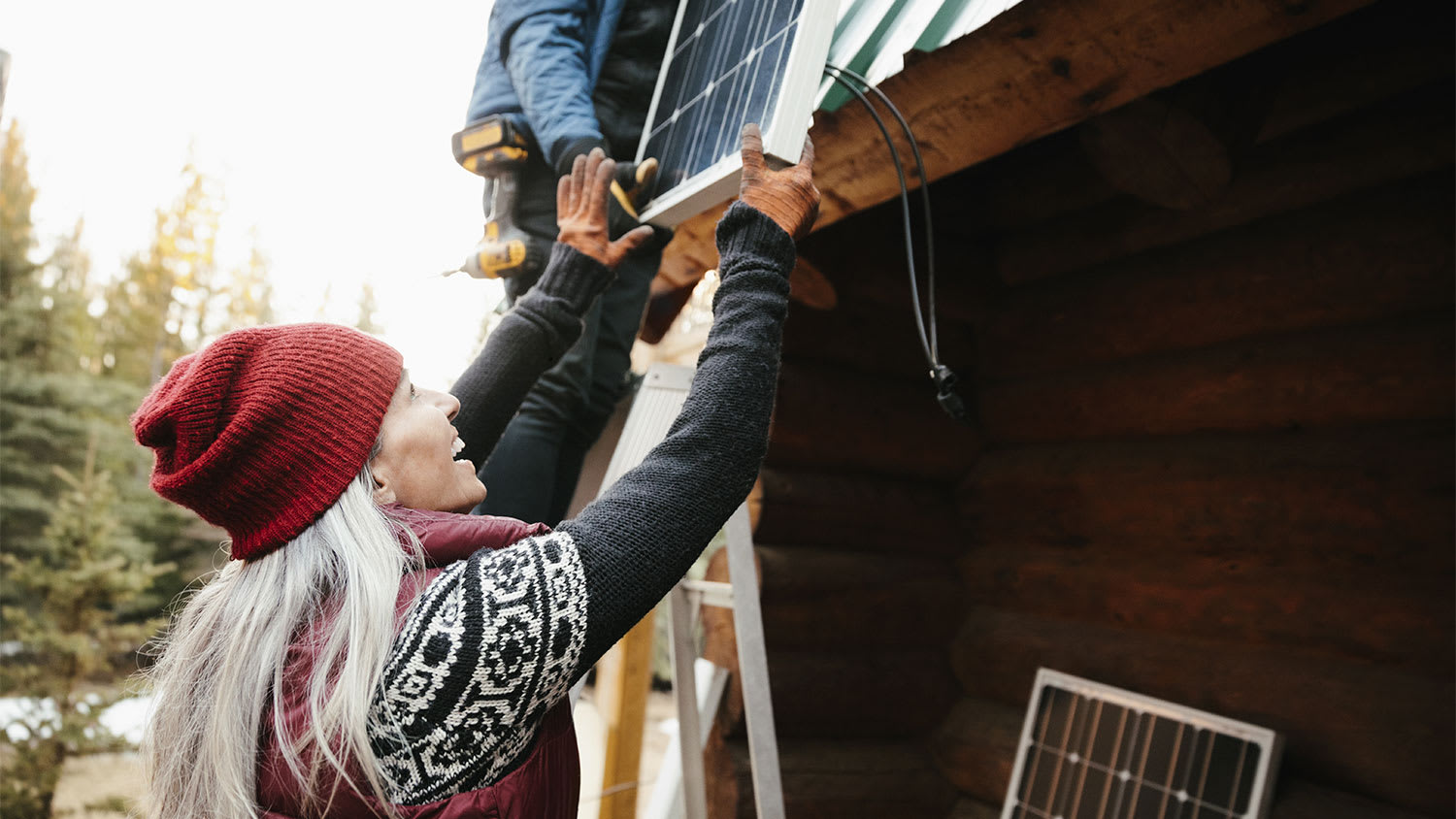 Happy woman installs solar panels