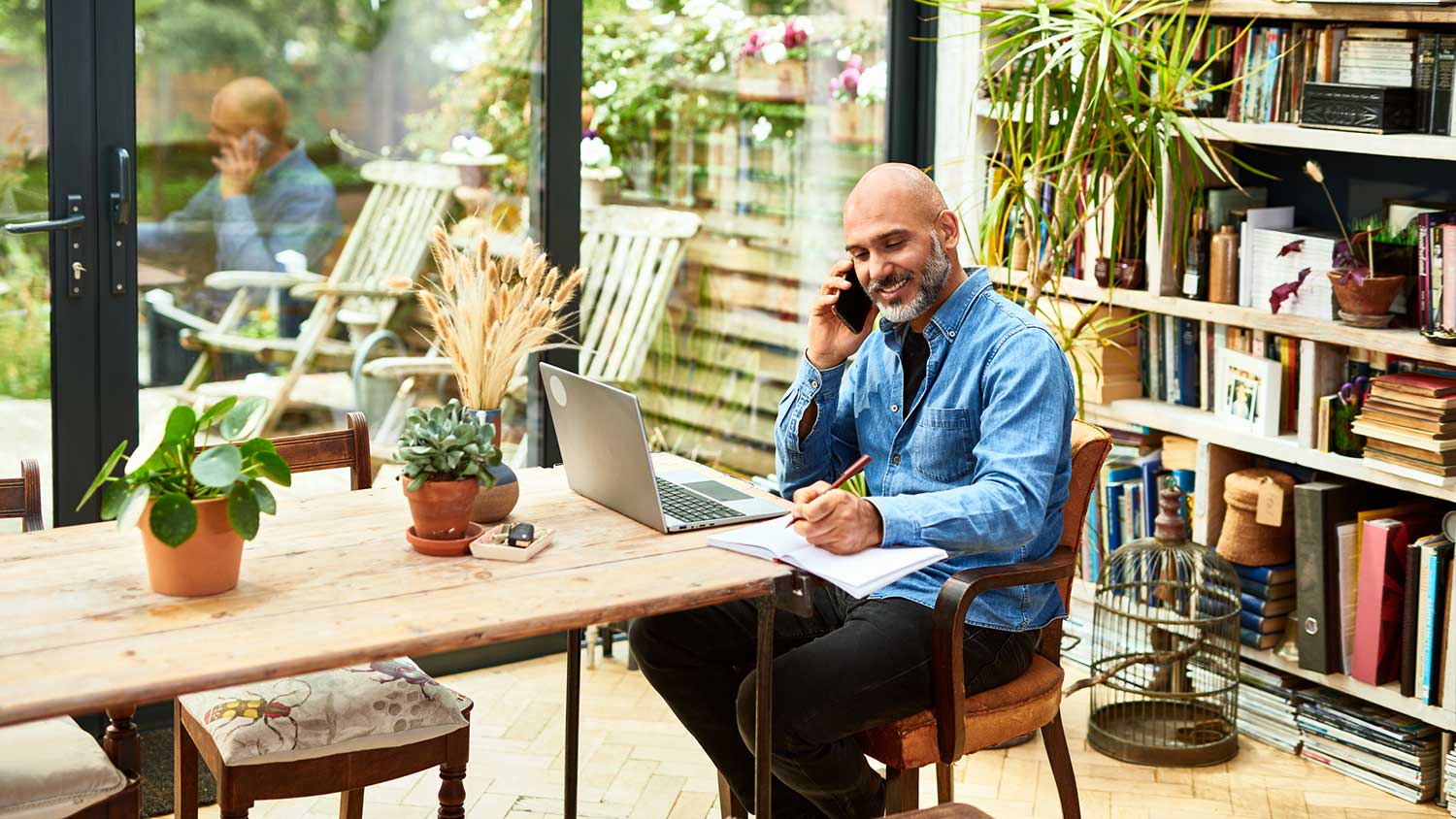 Man working with laptop on a table at home