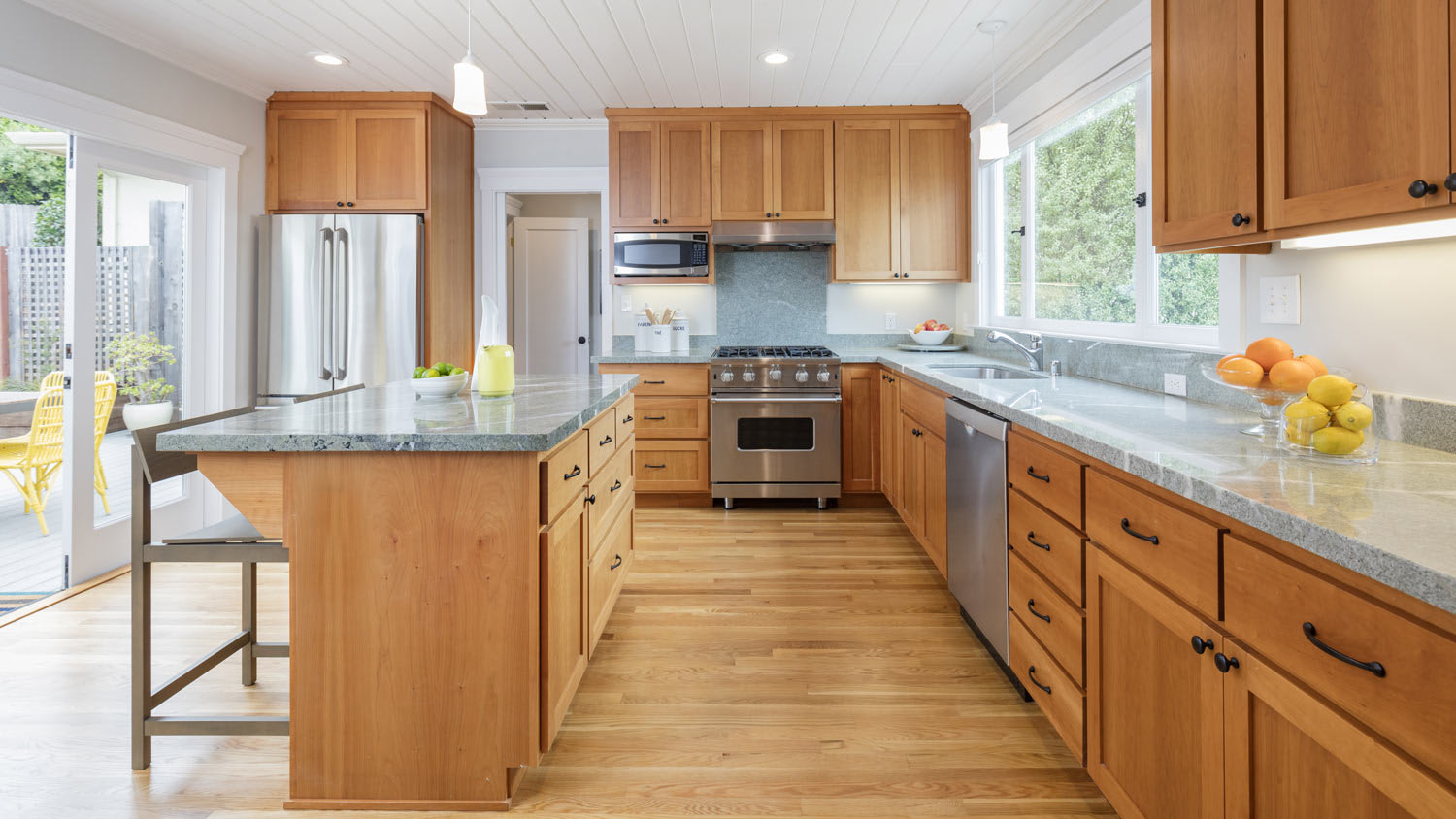A kitchen with wooden face-frame cabinets and granite countertops