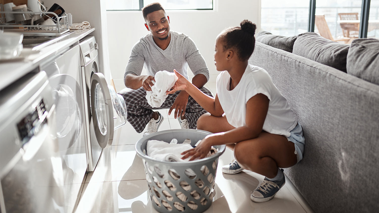 Couple taking laundry out of dryer