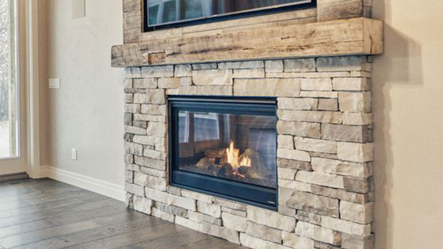 Stacked stone and wood fireplace