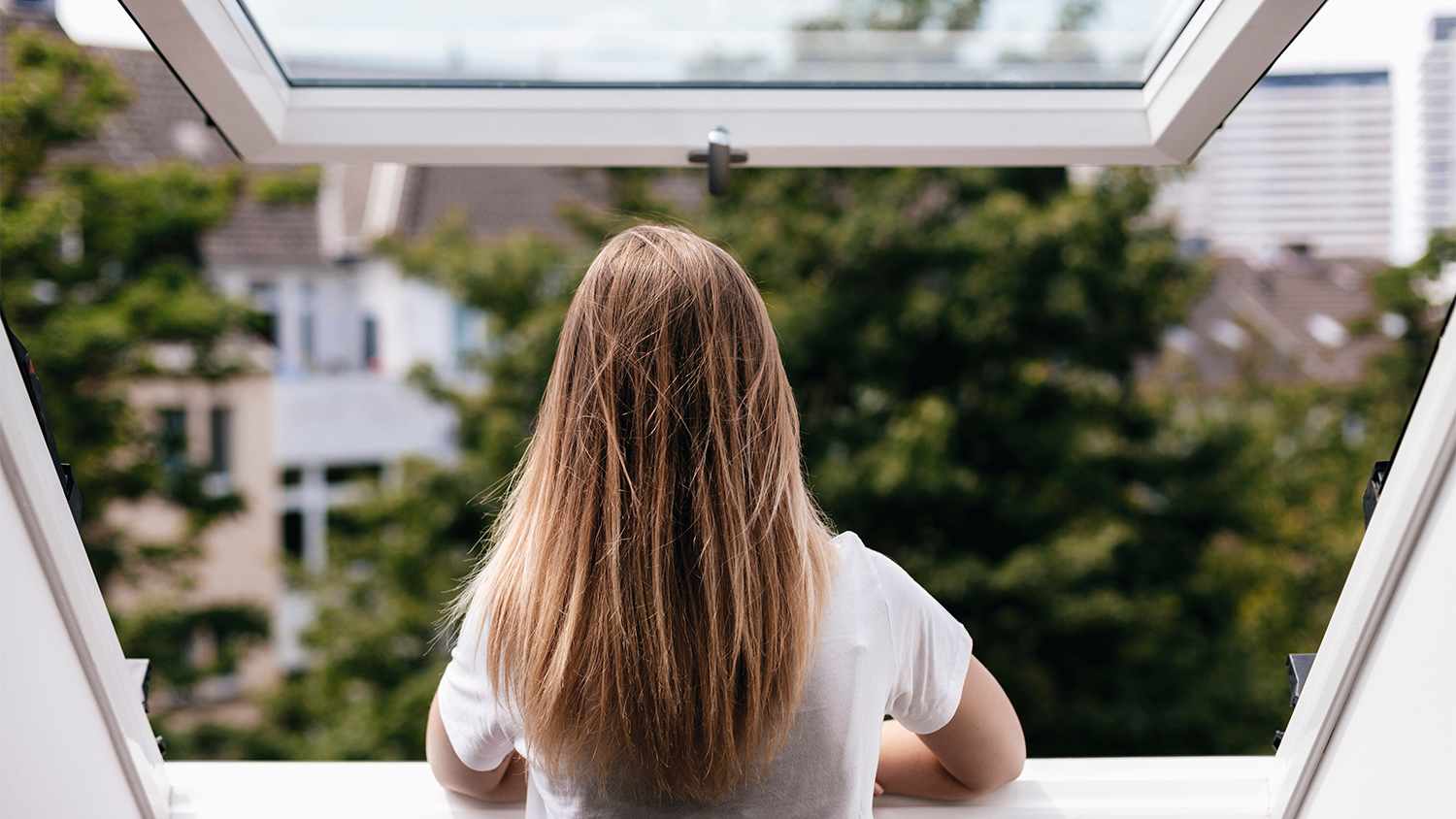 woman looking out awning style window