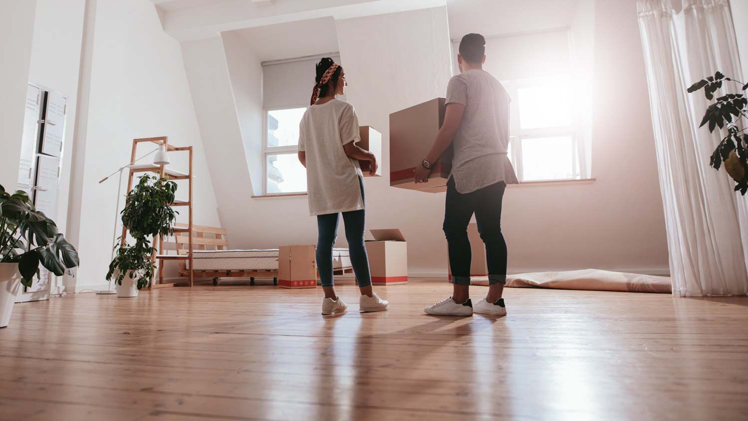 A young couple moving into their new house