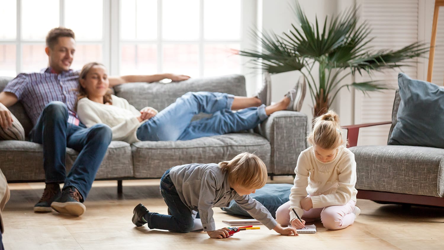 Family sitting in cool home
