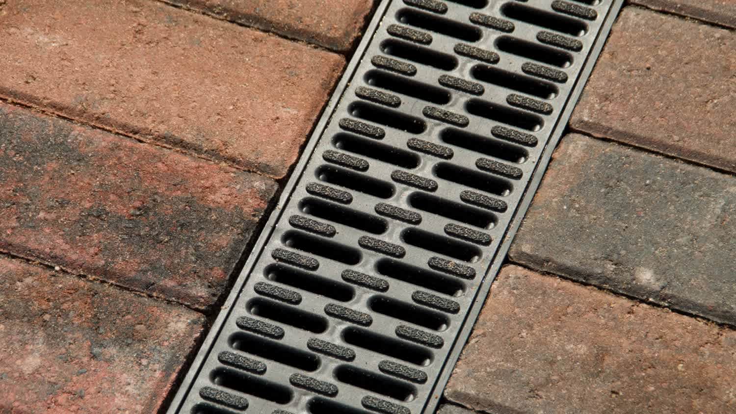A close up of a block paving drain