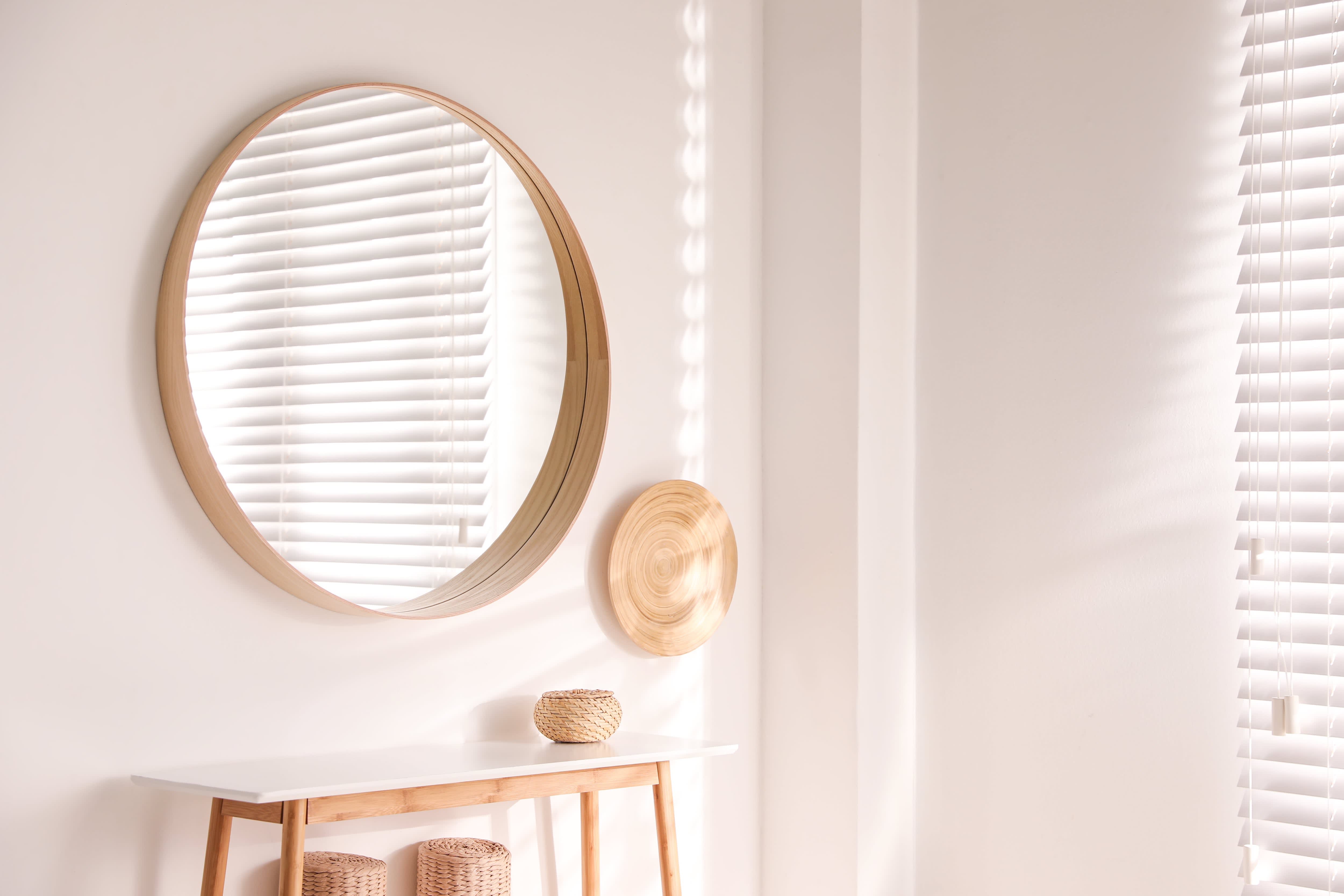 Large hanging circle mirror in room