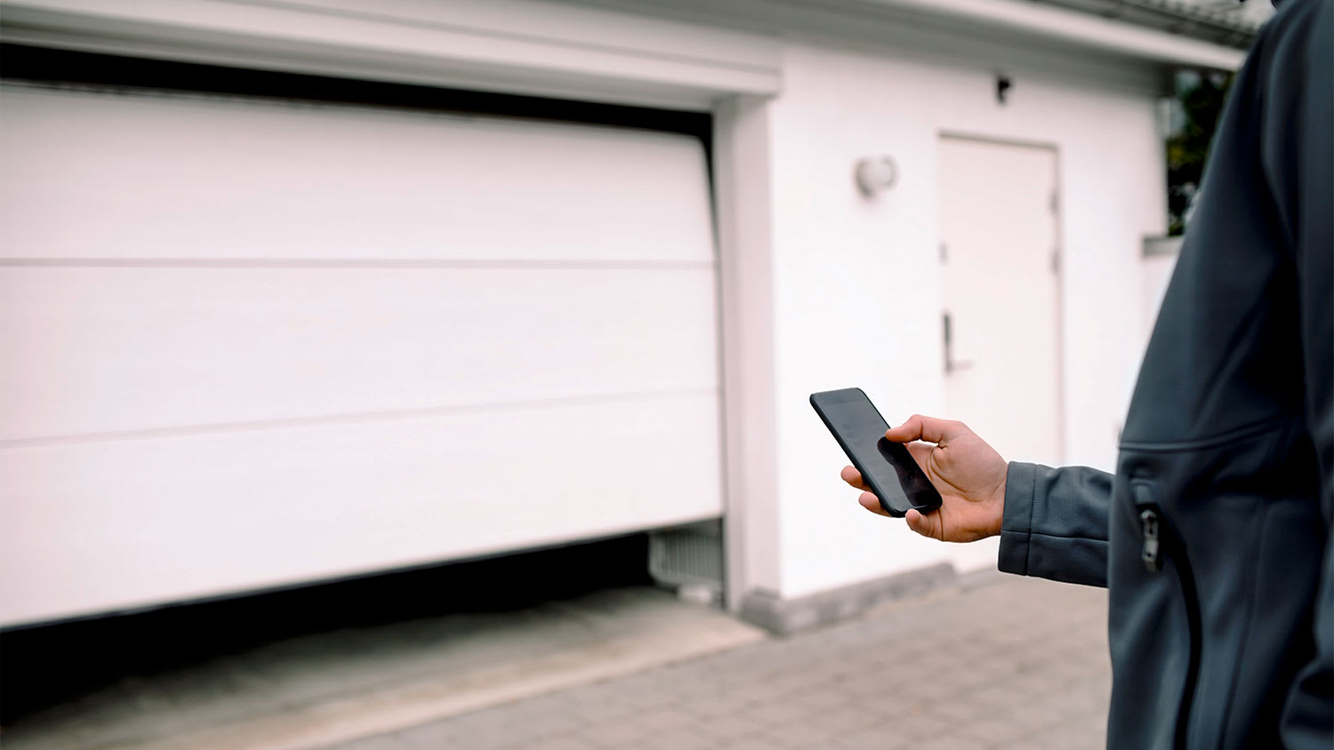 Man opening garage with phone