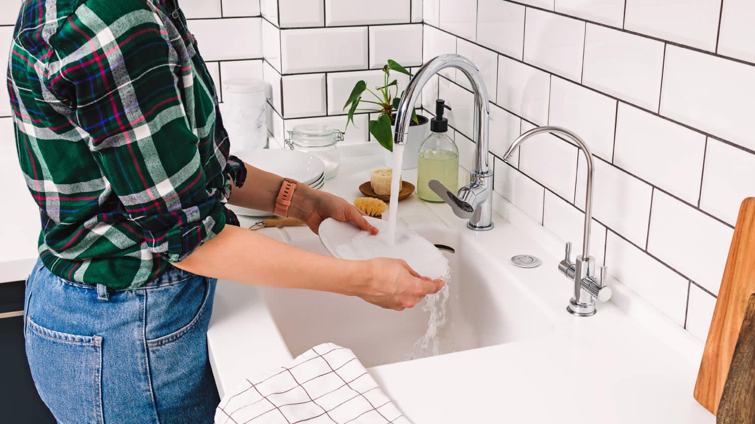 A woman washing dishes in the kitchen