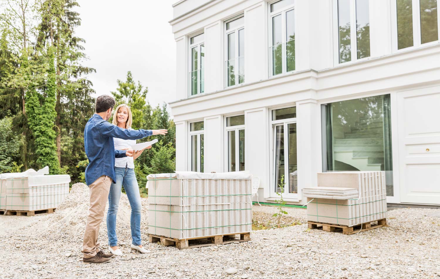 A contractor talking with a client outside her house