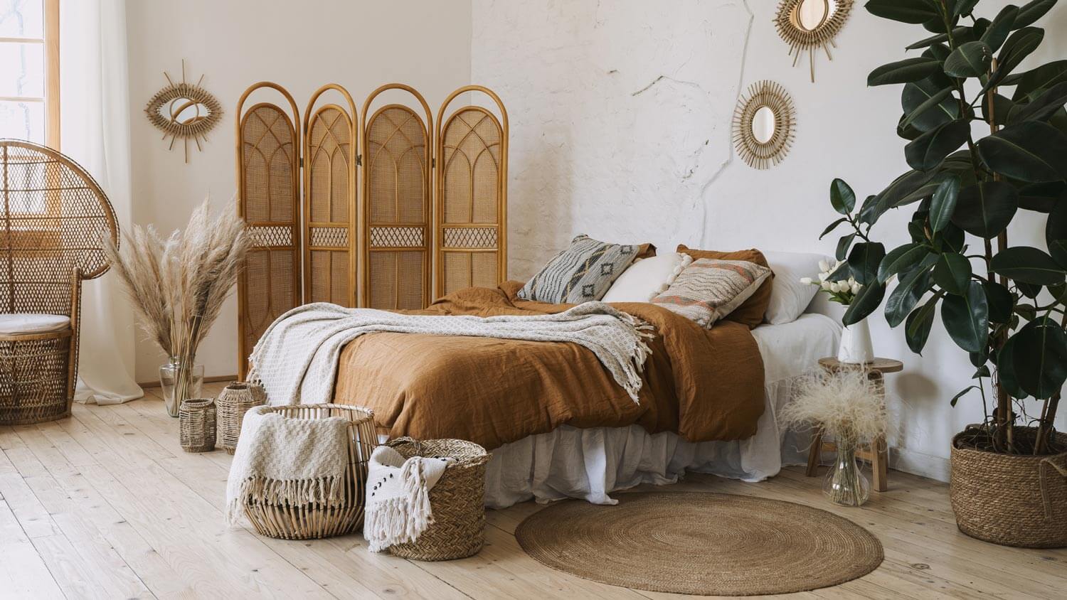 A boho bedroom with a houseplant on the floor