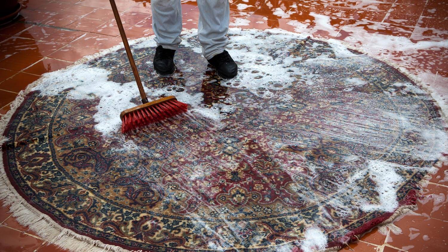 A man cleaning a carpet