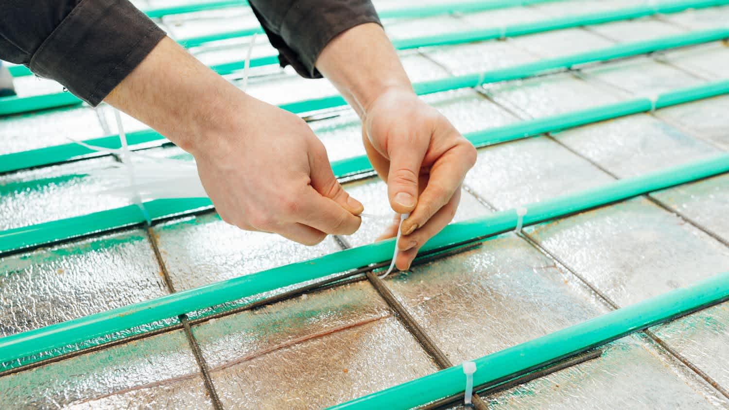 A professional installing new PEX pipes