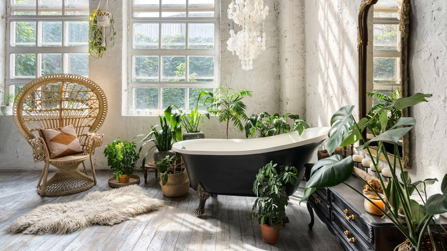 A retro bathtub in a spacious bathroom with lots of houseplants