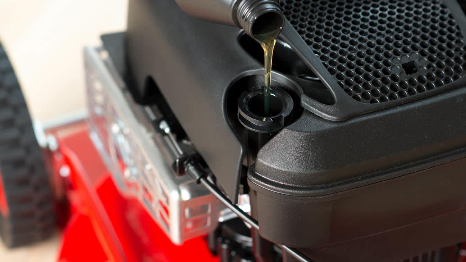 Filling oil in engine on a lawn mower