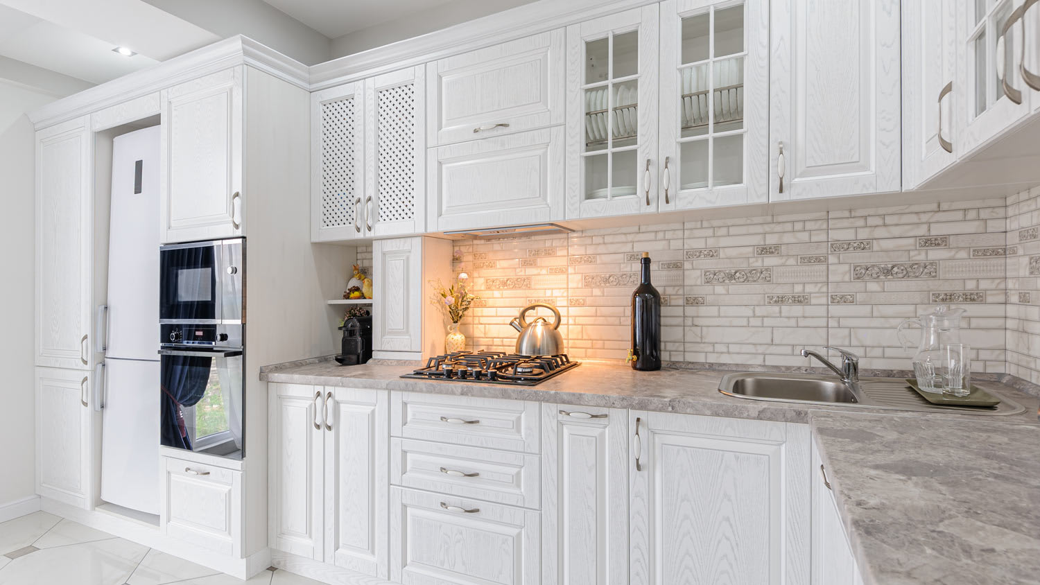 A spacious white kitchen with a soffit built above the cabinets