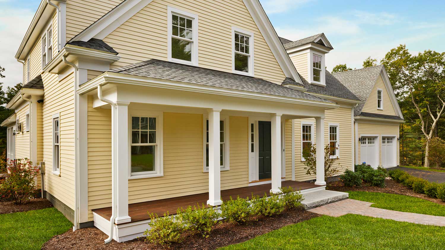Yellow home with front porch and attic