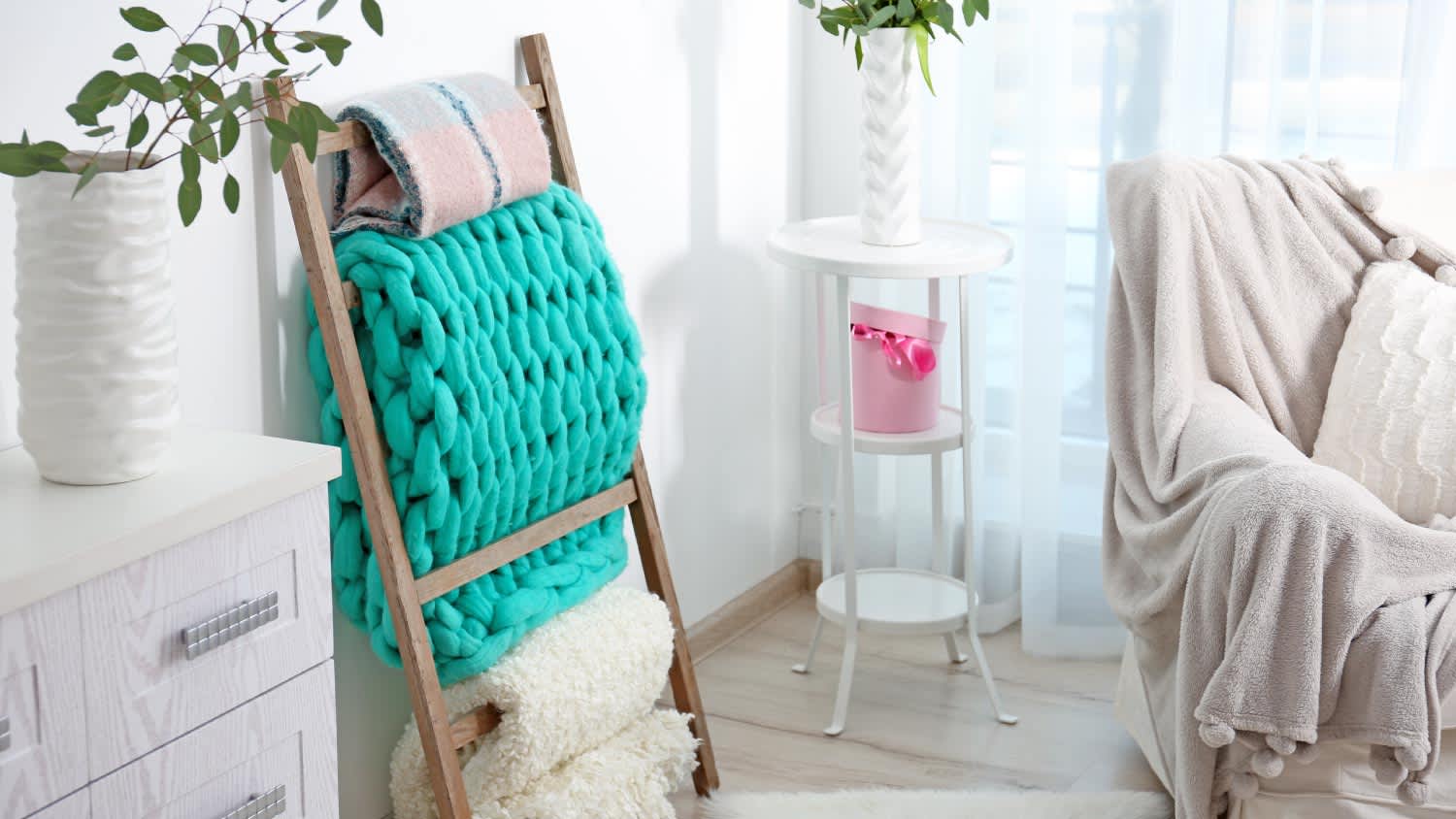 Warm plaids hanging on decorative ladder