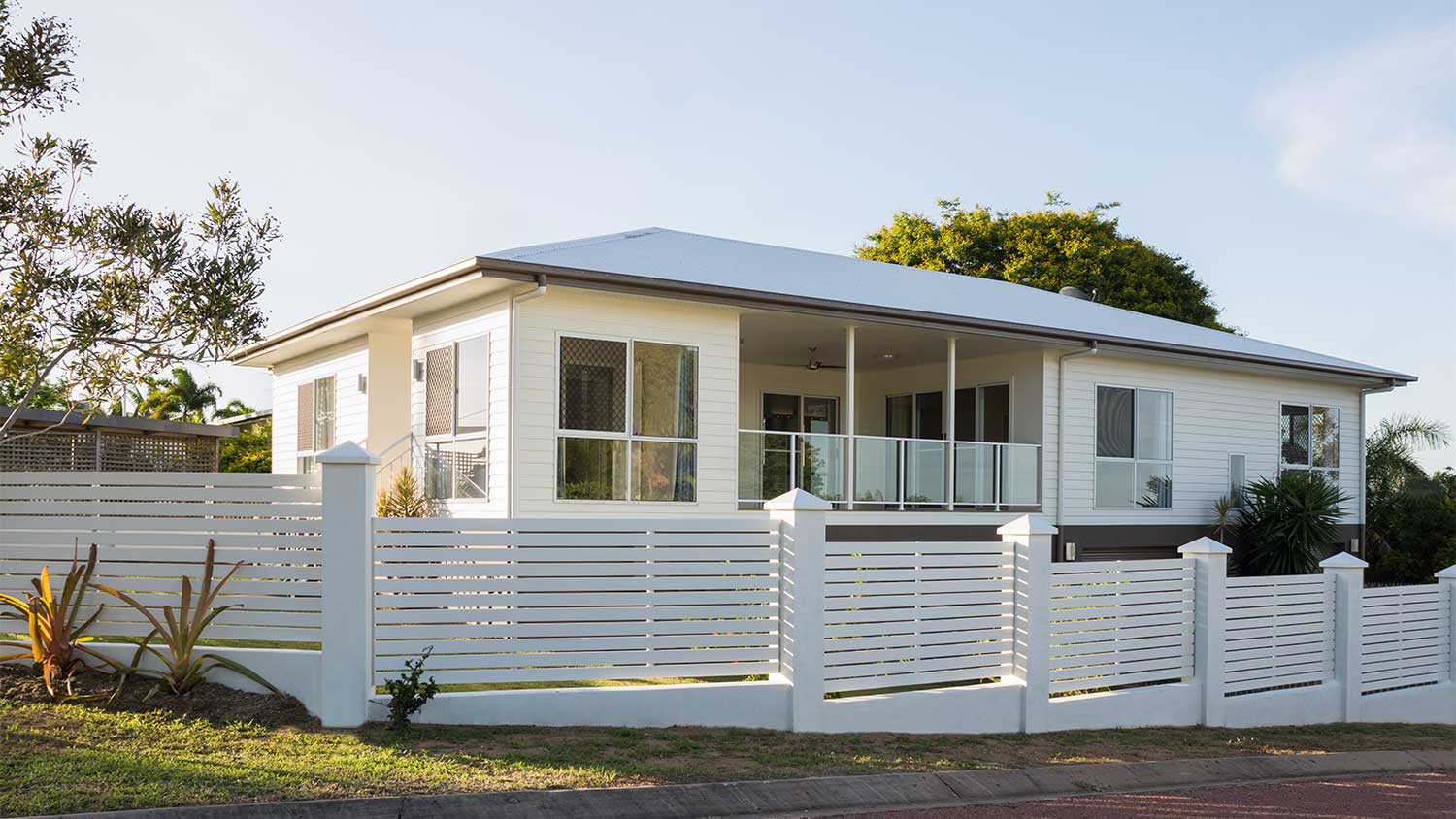House surrounded by a modern white fence