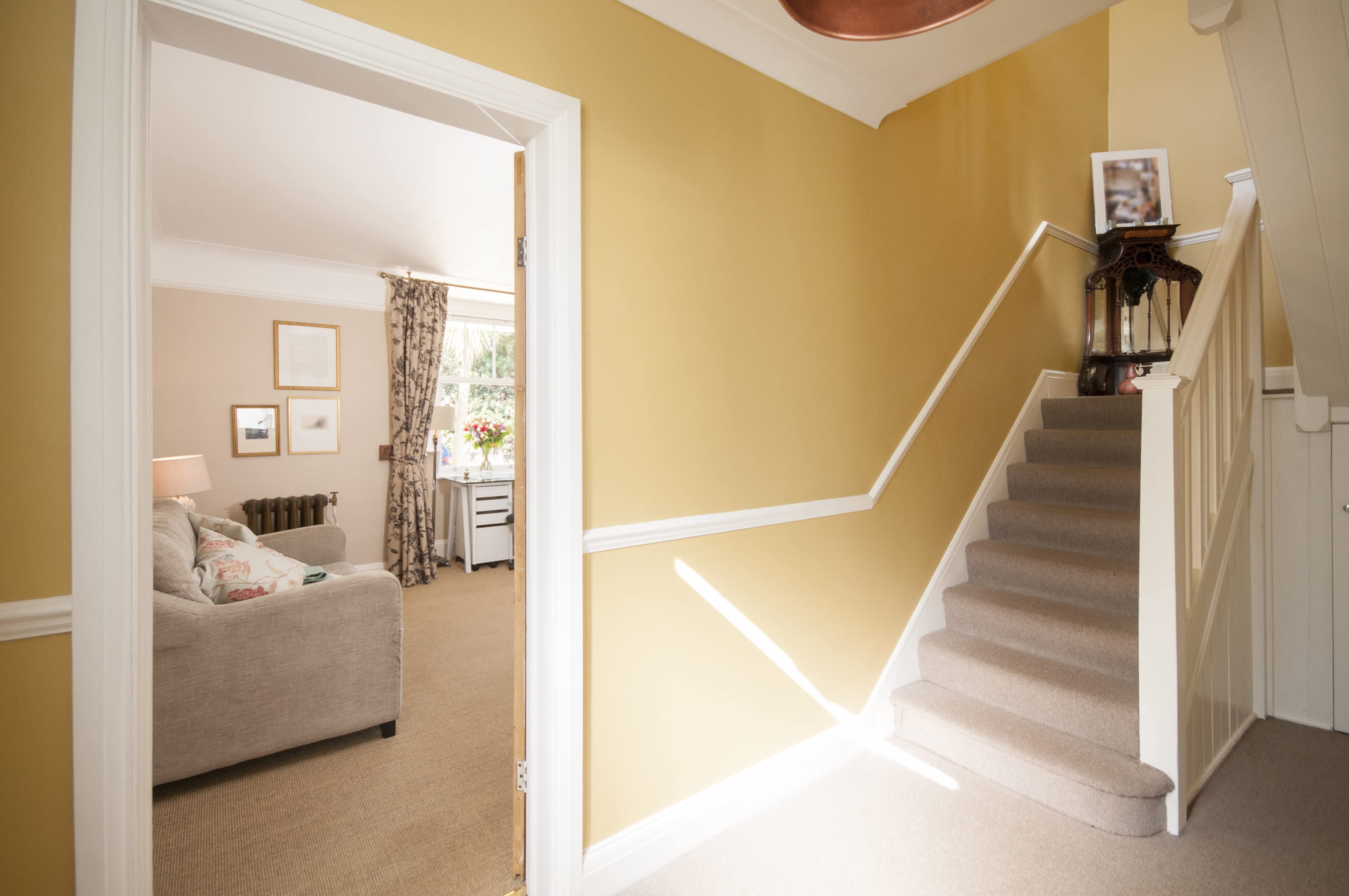 An interior staircase with a decorative accent table on the corner step