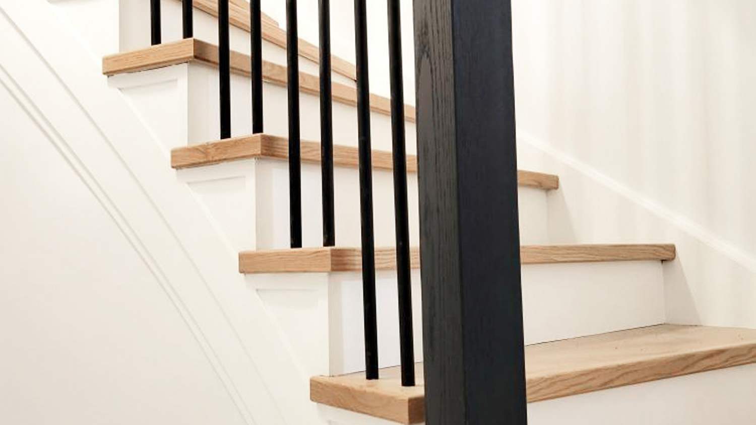 Brown wood steps black rails white