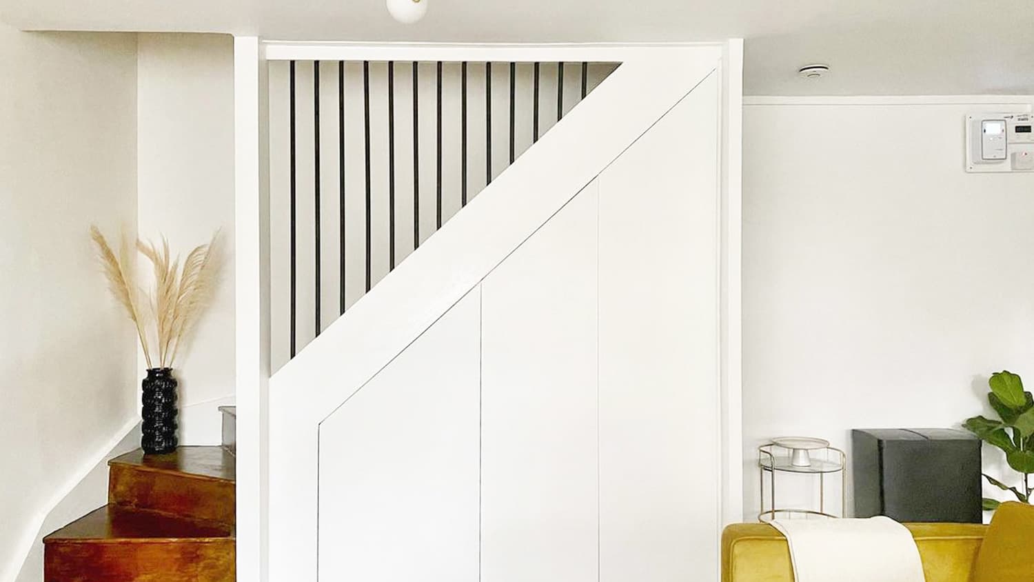 White wall wood stairs black railings