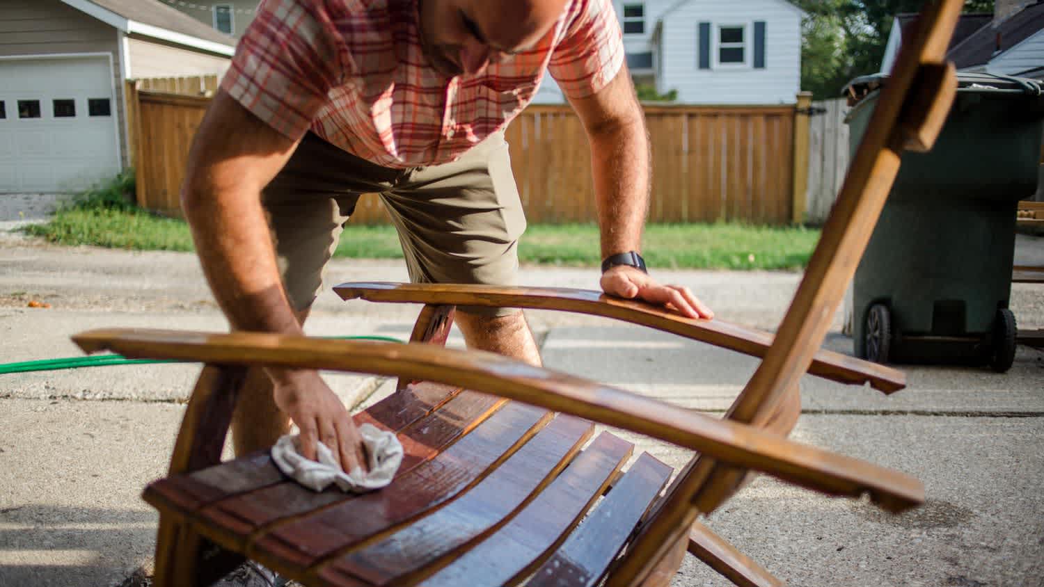 A man cleaning a lounge chair for this patio