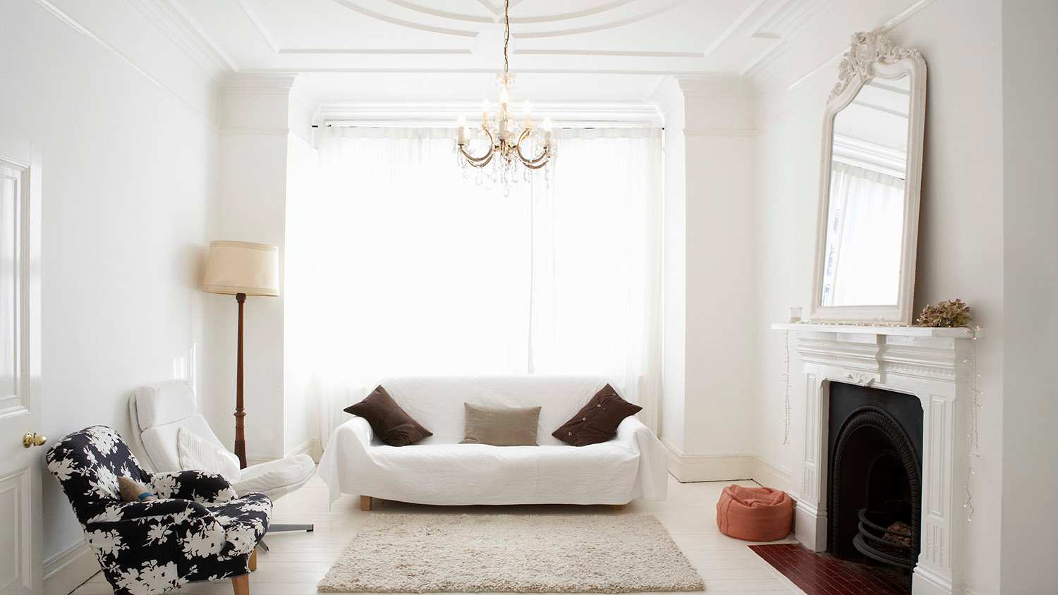 white living room with mirror on mantle