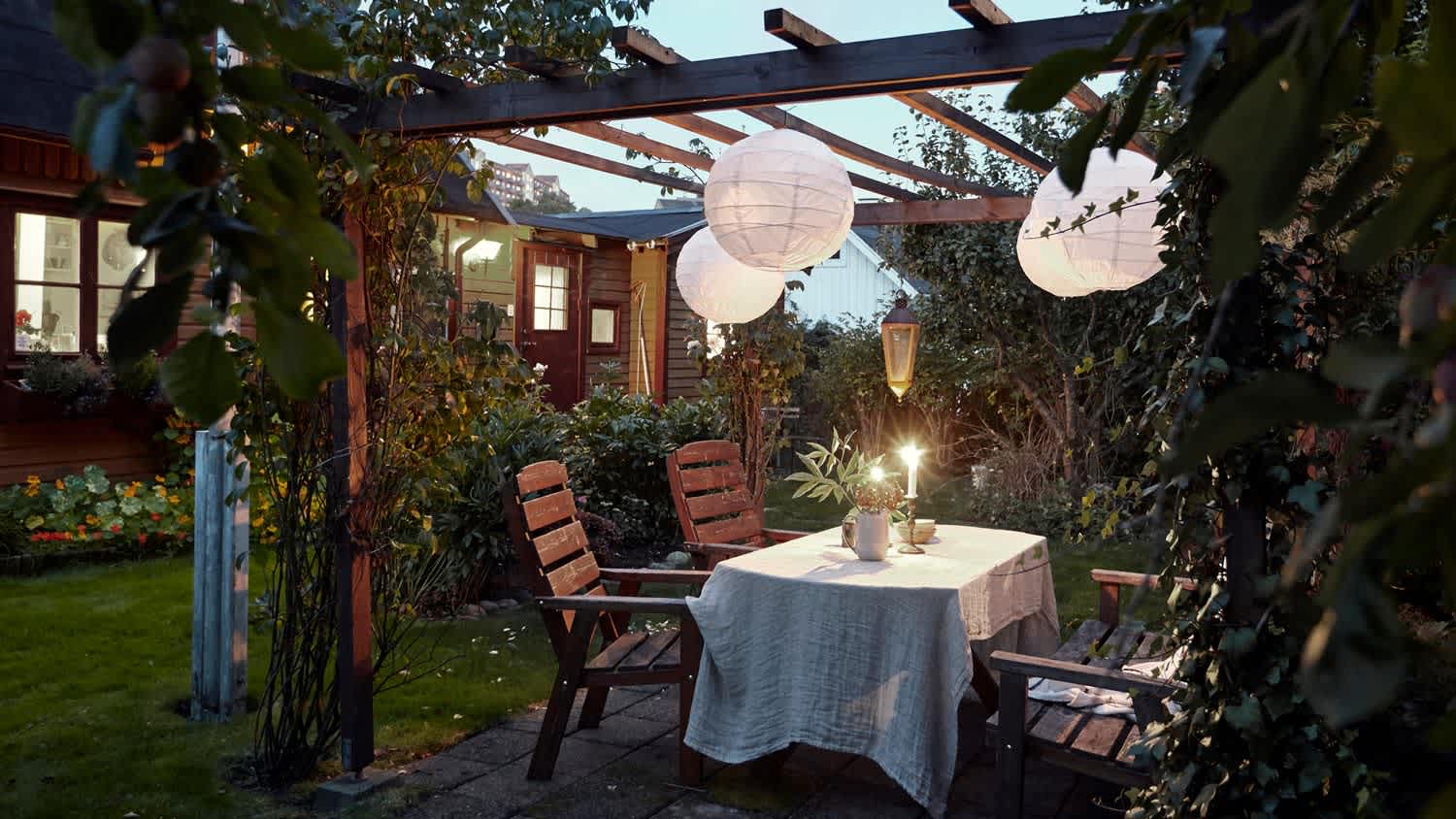 A patio table set for dinner at dusk