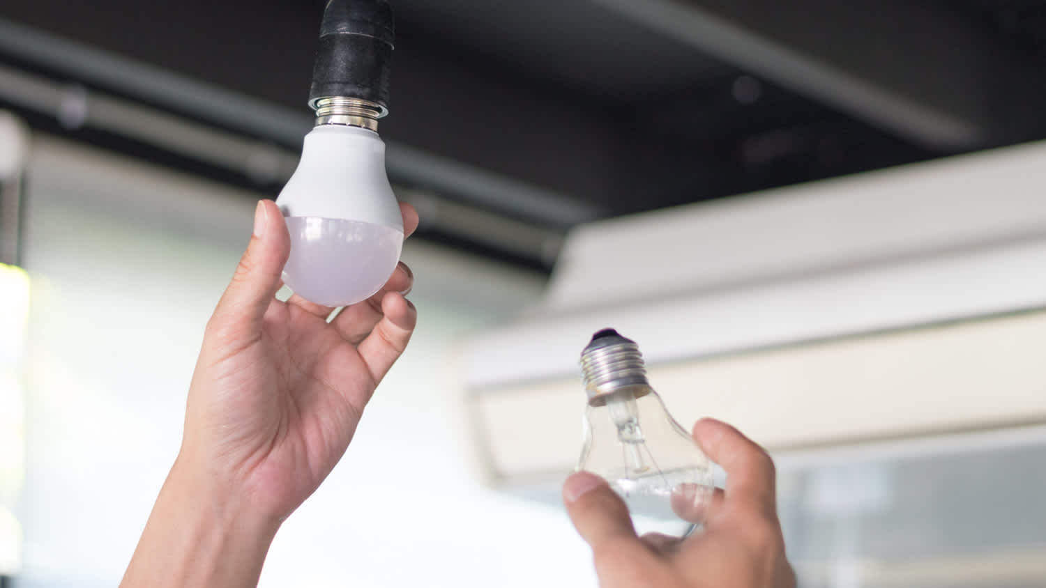 A man switching to LED bulb from a fluorescent