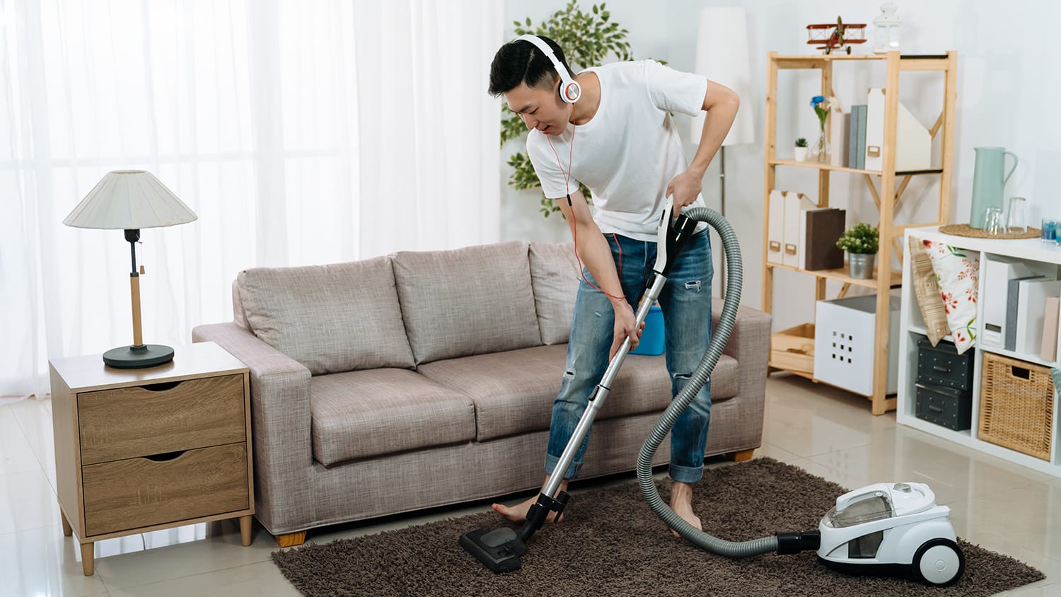 Man vacuums carpet