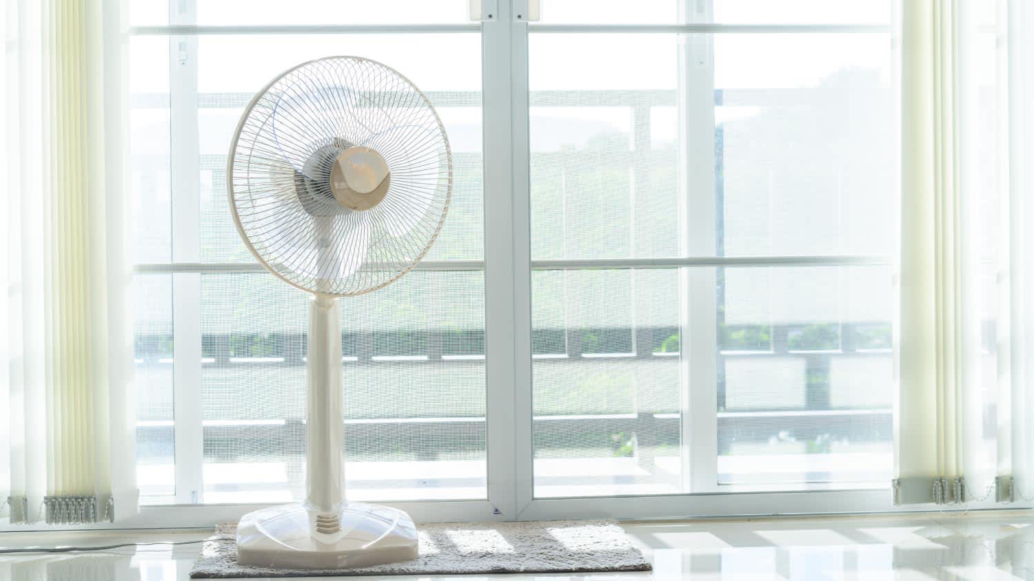 Fans placed in front of the curtains in the room
