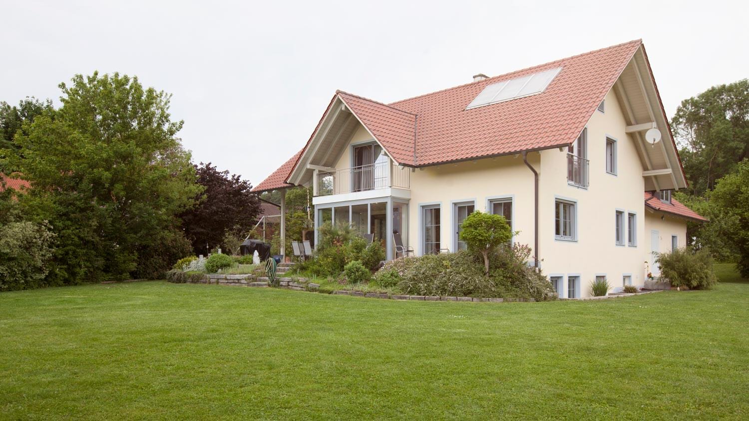 A house with a large garden with lawn