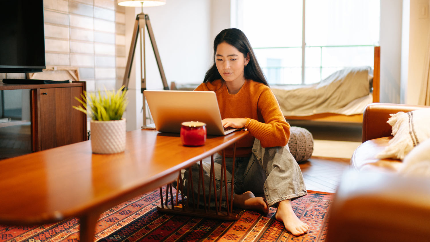 A woman using her laptop on the coffee table
