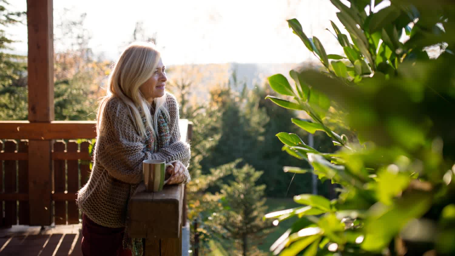A woman standing by wooden house