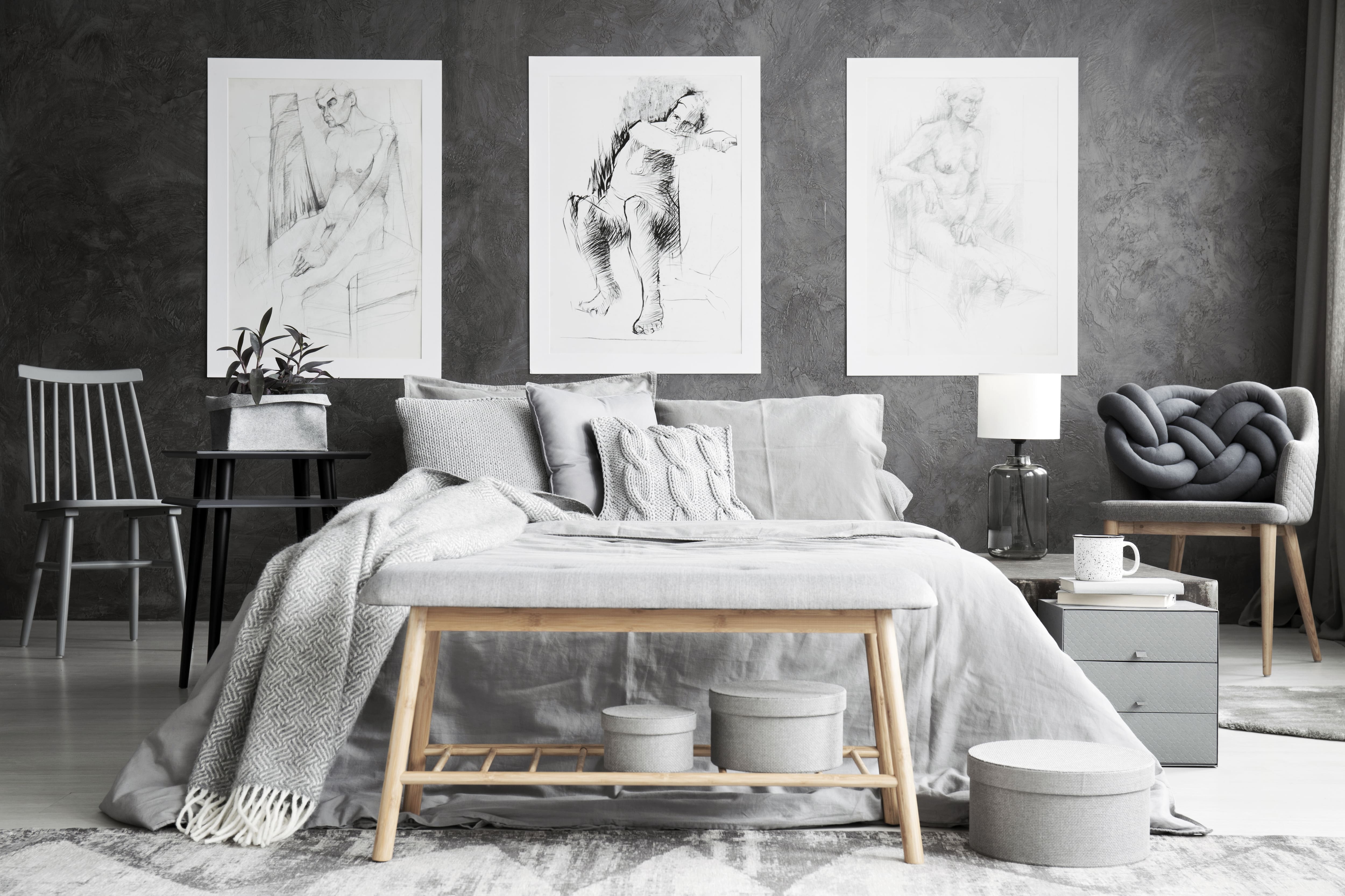 Monochromatic gray bedroom with a bed, lights and pillows
