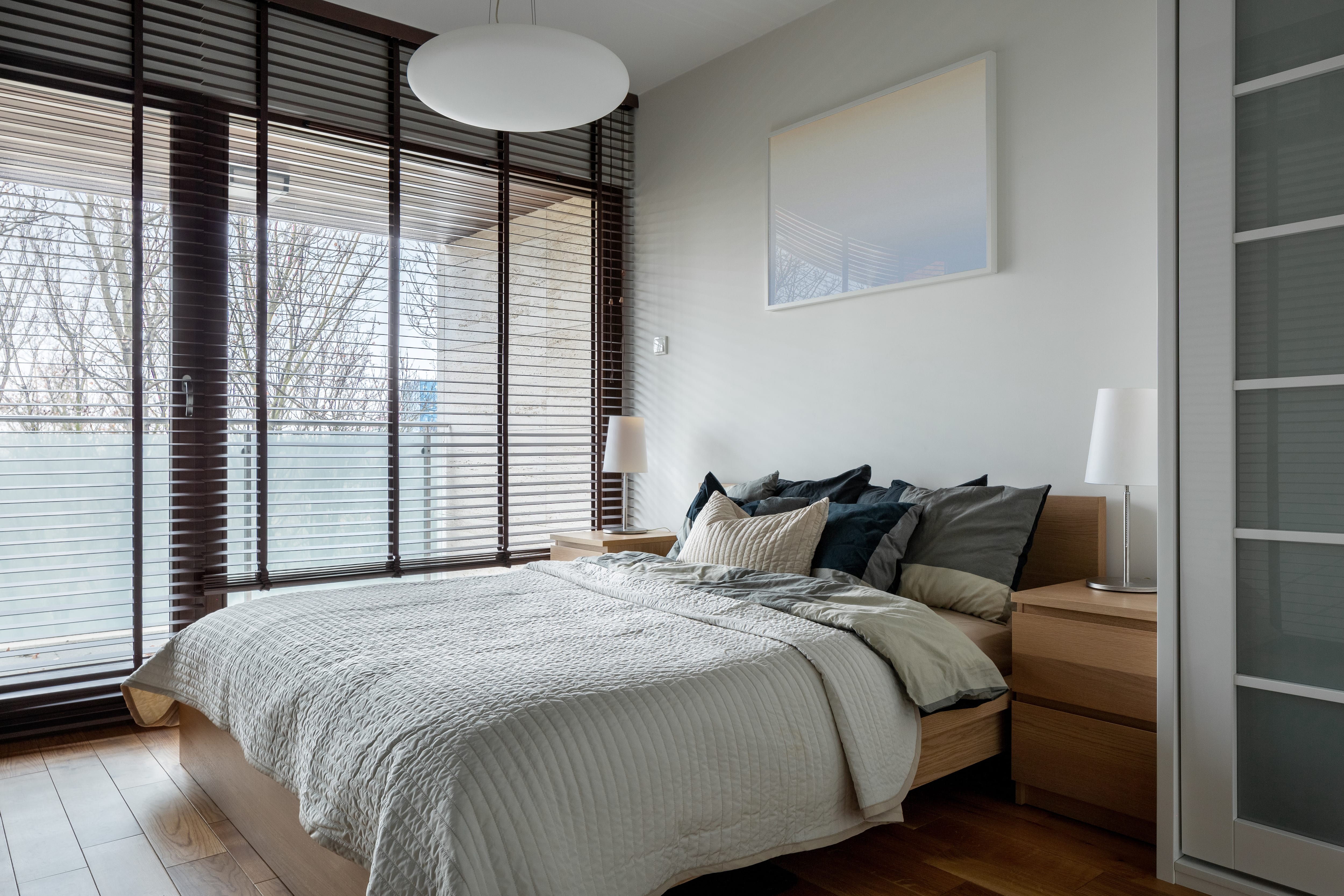 Simple neutral colored bedroom with big windows and natural light
