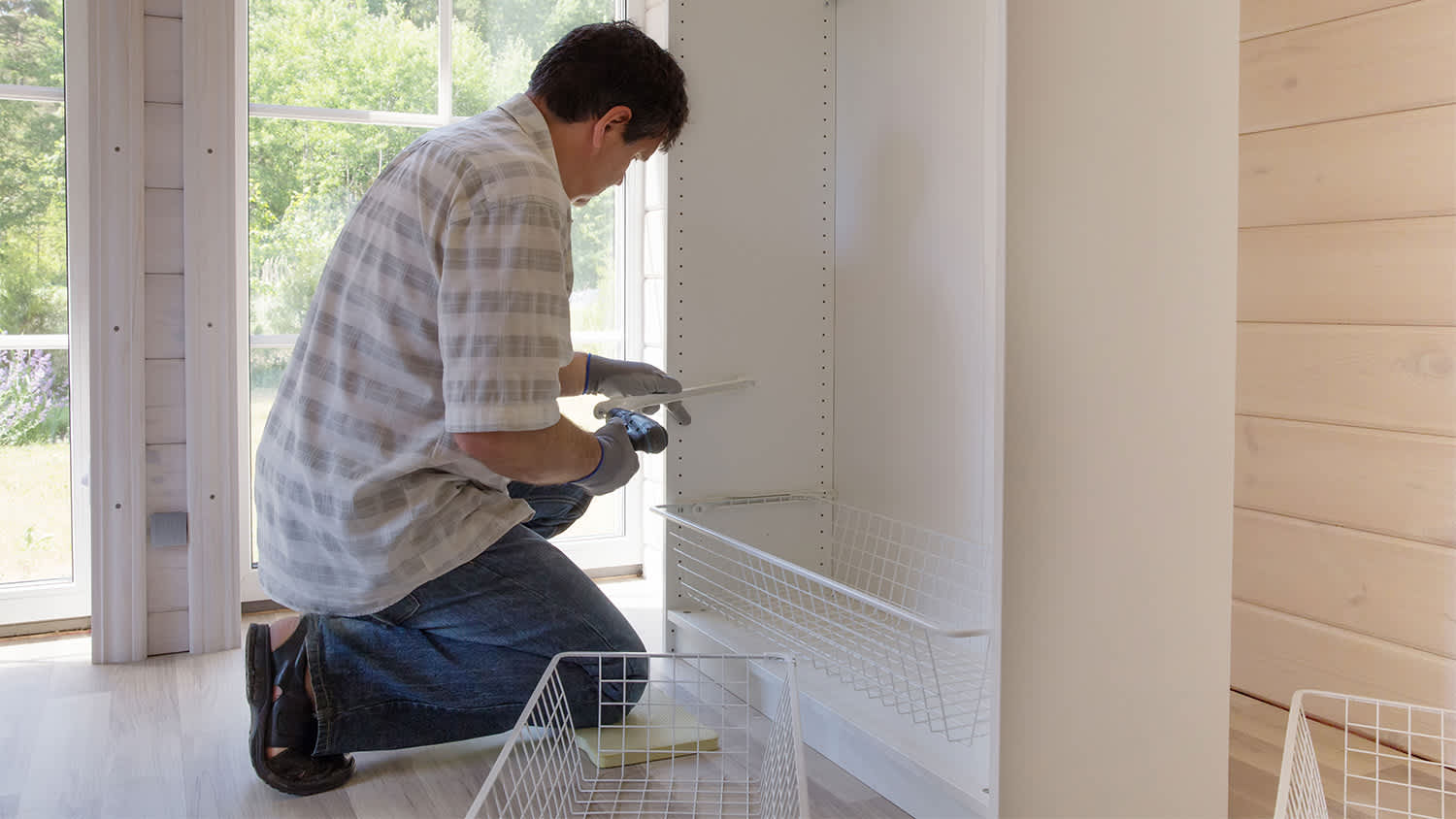 man adding basket shelving to closet