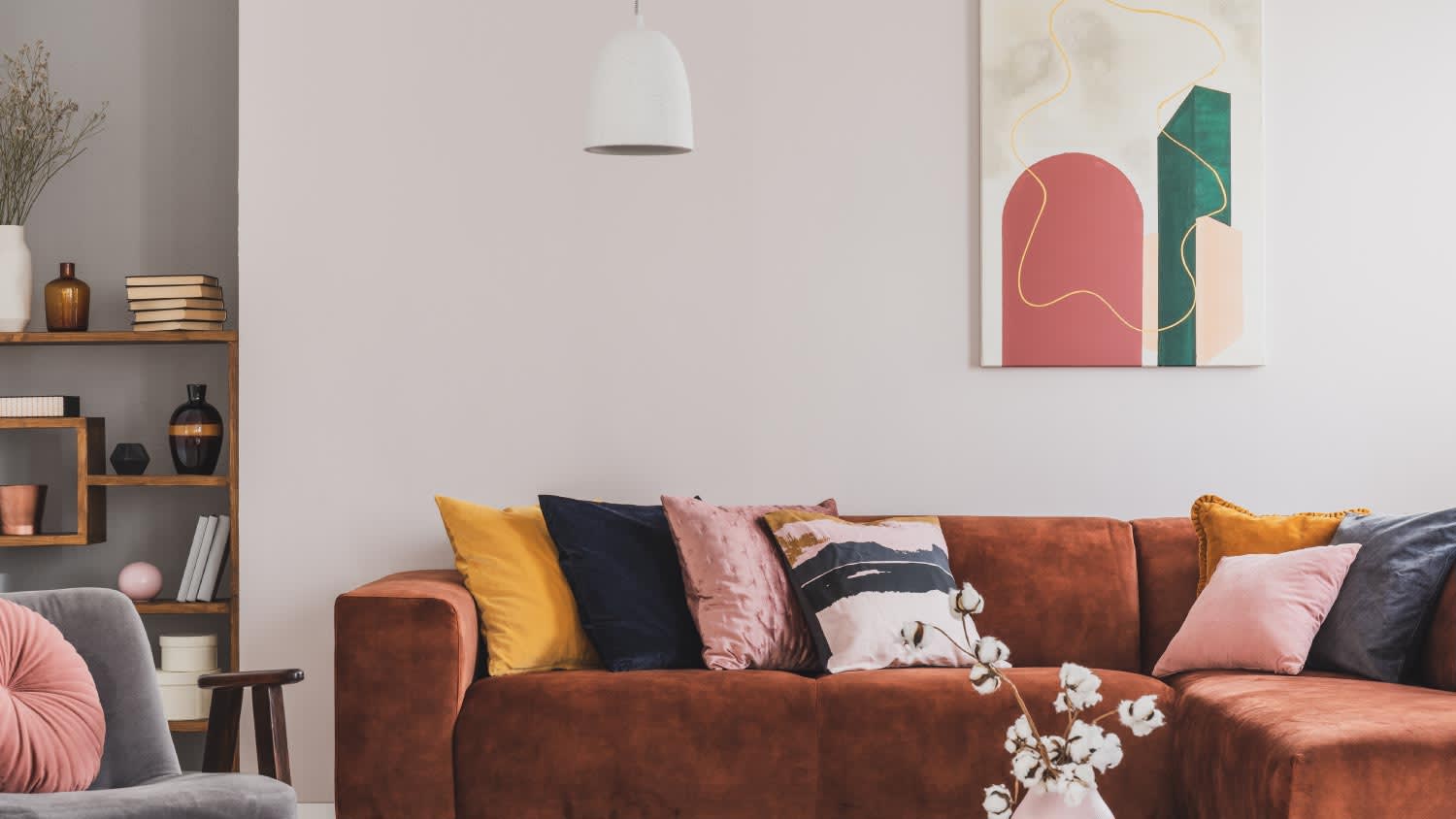 A living room with an abstract painting and sofa