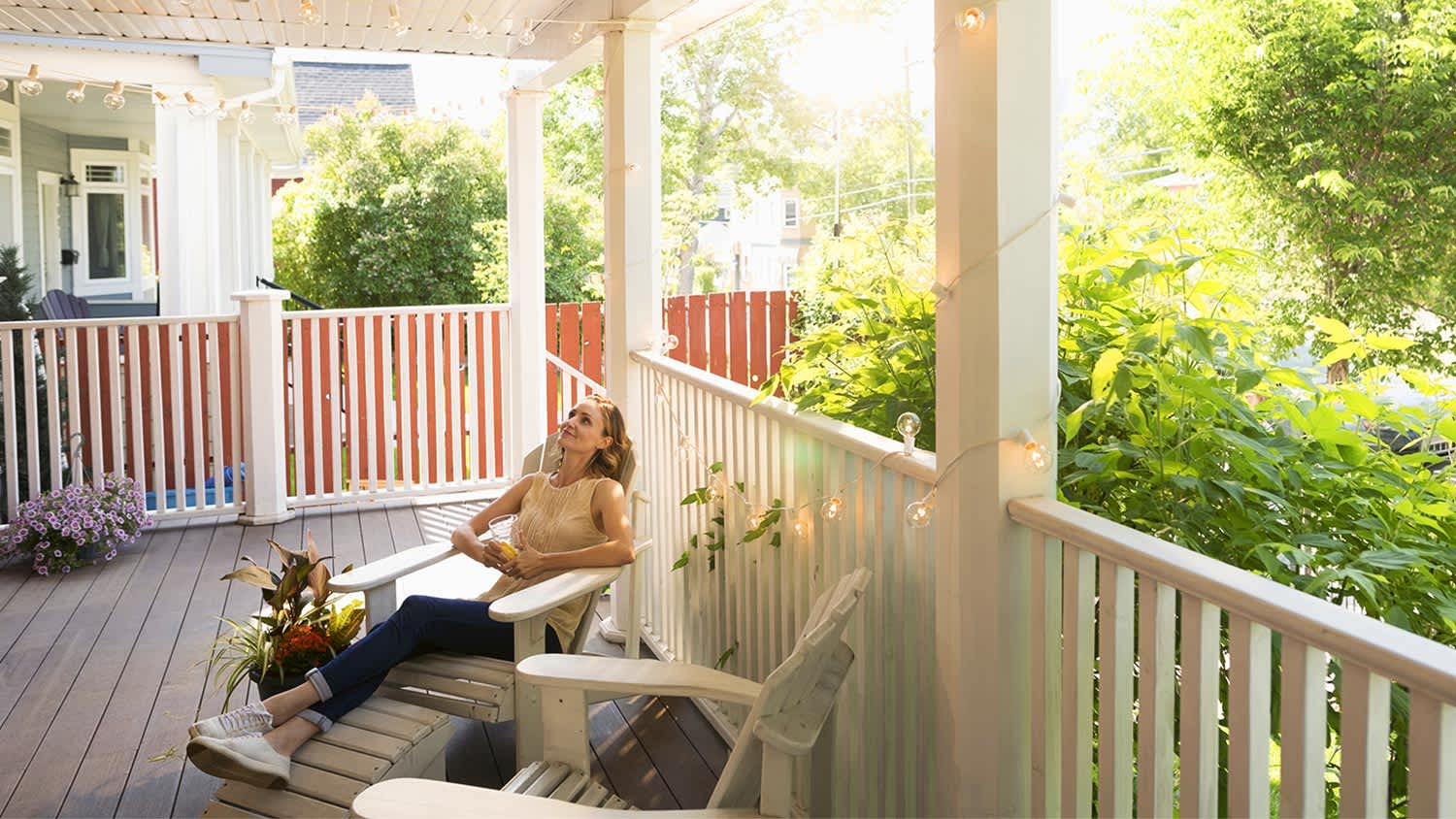 Woman relaxing in a chair on porch.