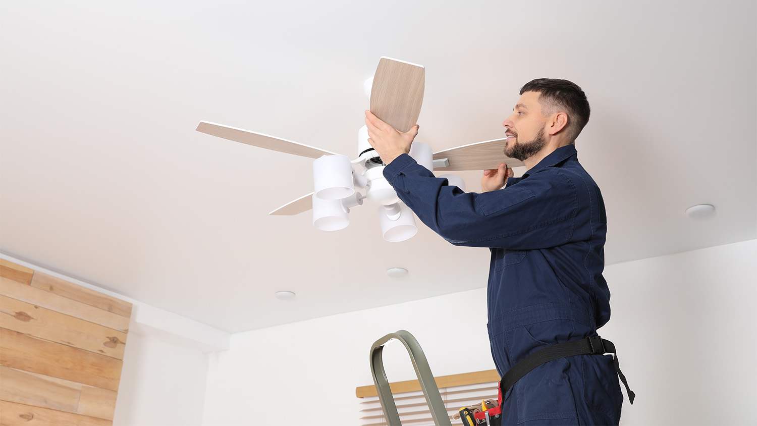 electrician installing ceiling fan