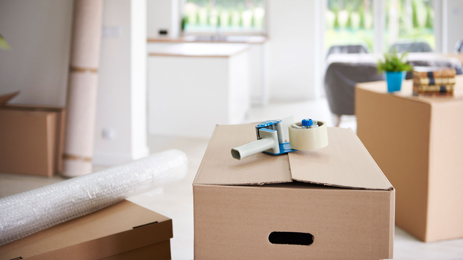 Tape gun on top of a cardboard box