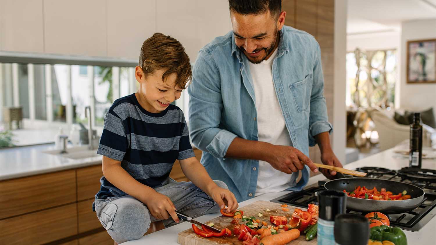 father and son cooking together in the kitchen