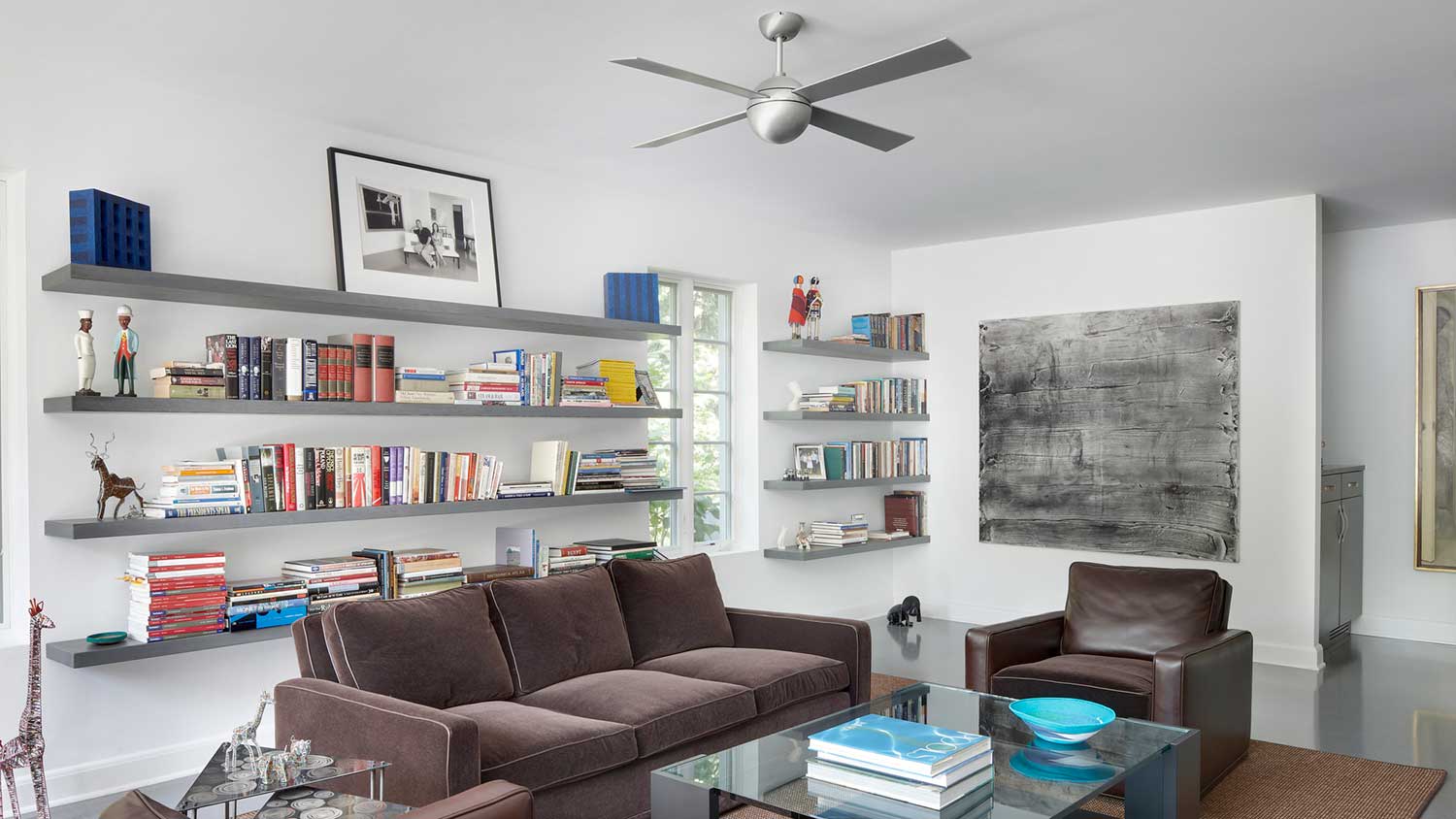 Modern family room with books and ceiling fan