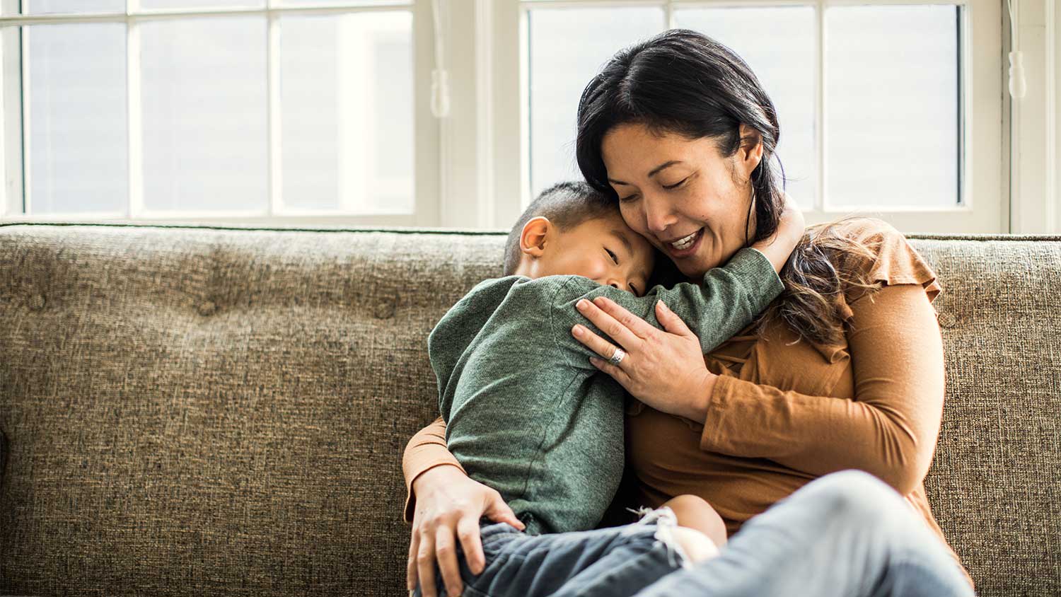 Mother and son hugging at home