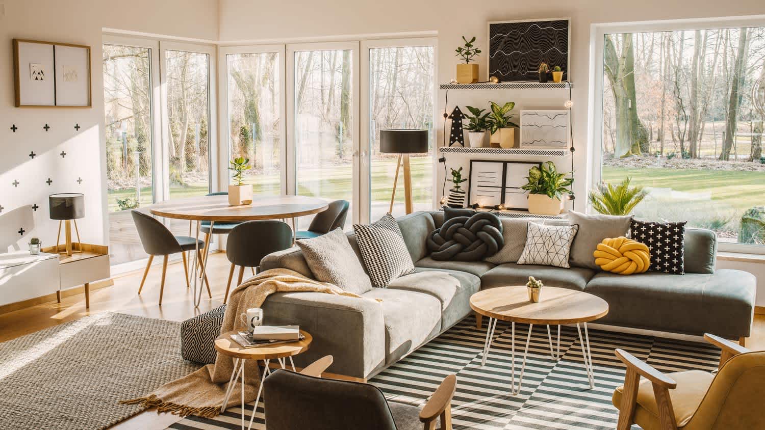 An open plan living room with nordic furniture and large windows