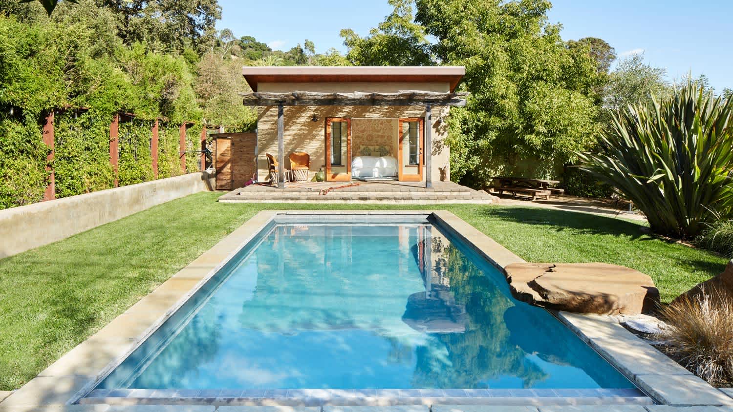 A pool and a pool house in a Californian home