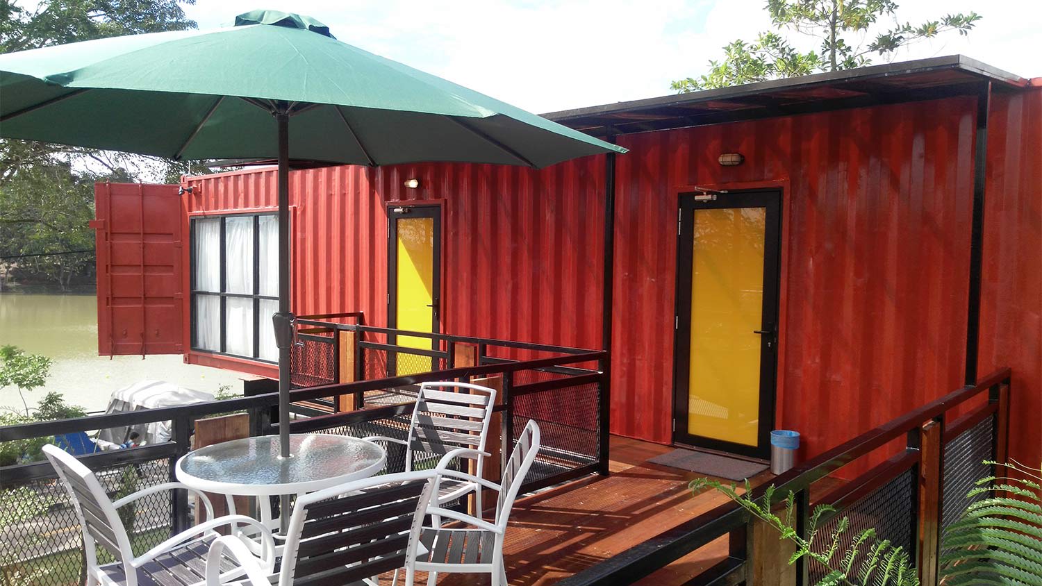 Red shipping container home patio umbrella