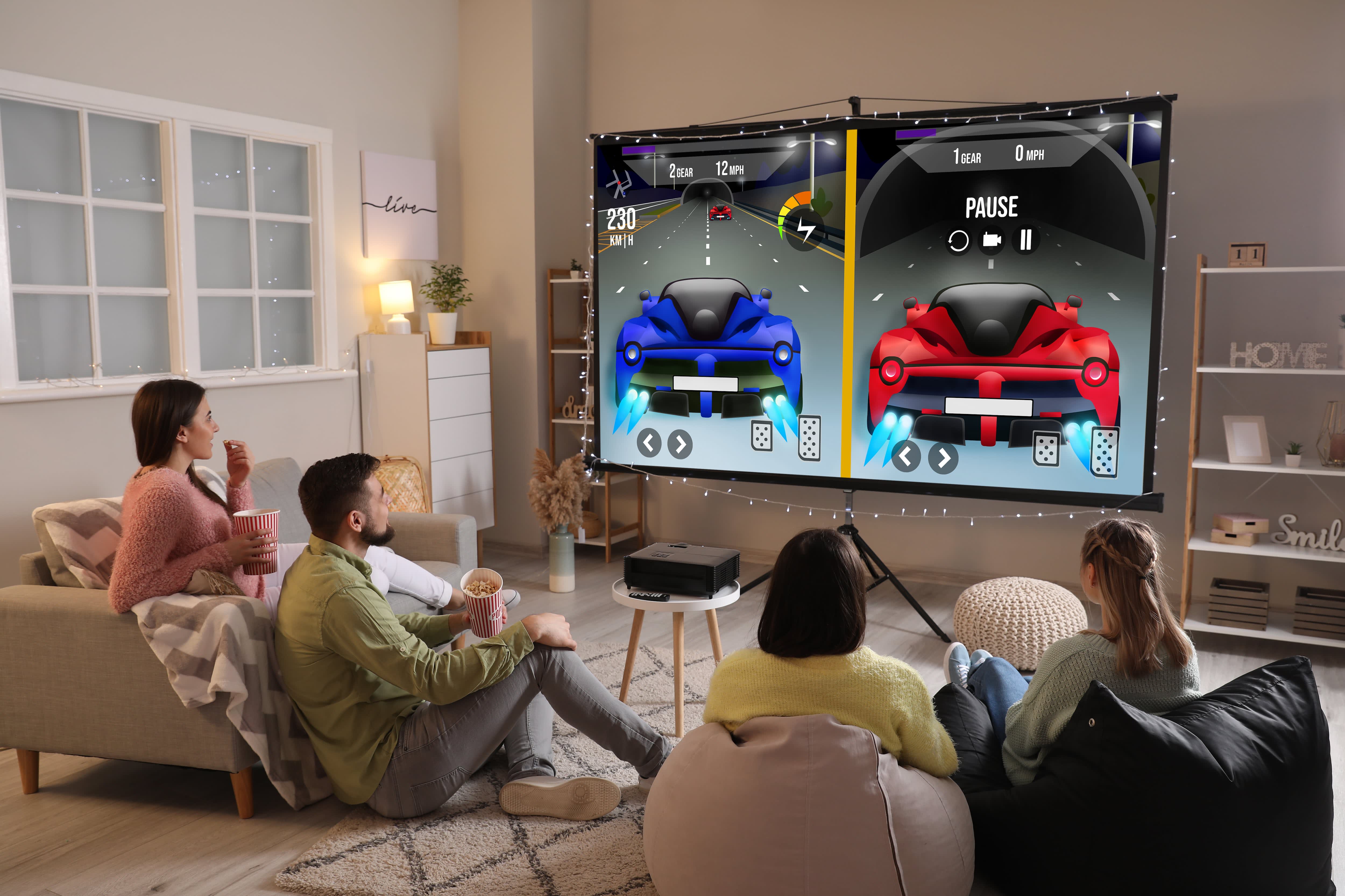 Friends playing video games on projector screen